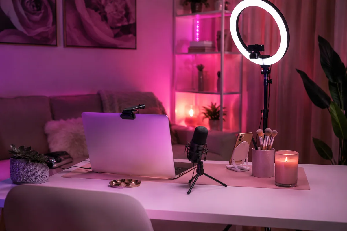 Home webcam model workspace with a camera, ring light, microphone, and laptop